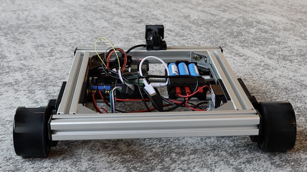 A SCUTTLE robot on a carpeted floor.